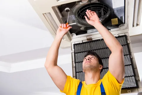 Image elaborates that a man is fixing AC Duct showcasing Air conditioning Repair Sun City Center.