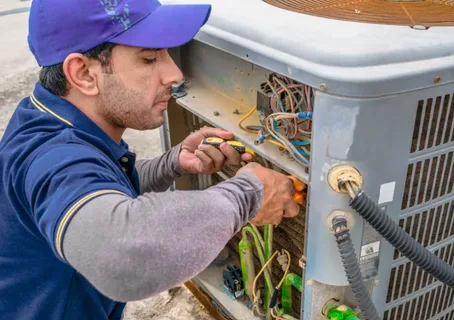 A man is repairing AC outer showing Air conditioning Repair Zephyrhills